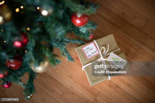 beautiful gift under the christmas tree - christmas presents under tree stock pictures, royalty-free photos & images