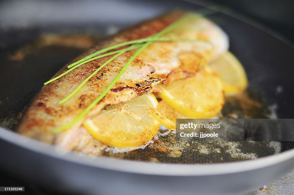 Fresh trout cooking in skillet