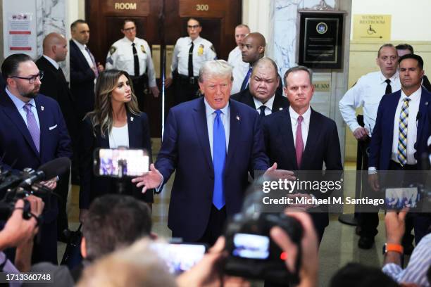 Former U.S. President Donald Trump speaks to the media as he arrives for the start of his civil fraud trial at New York State Supreme Court on...