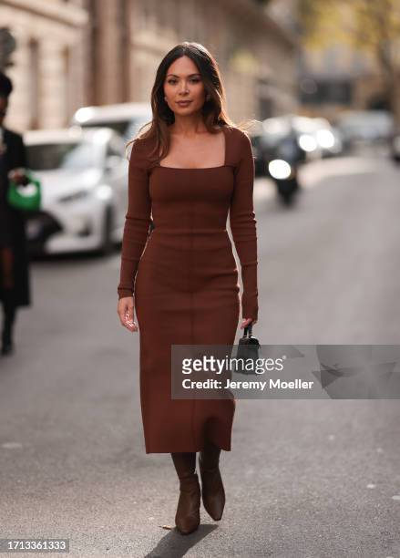 Fashion Week guest was seen wearing brown heels, a brown dress and a black hermes mini kelly bag before the Victoria Beckham Show during the...