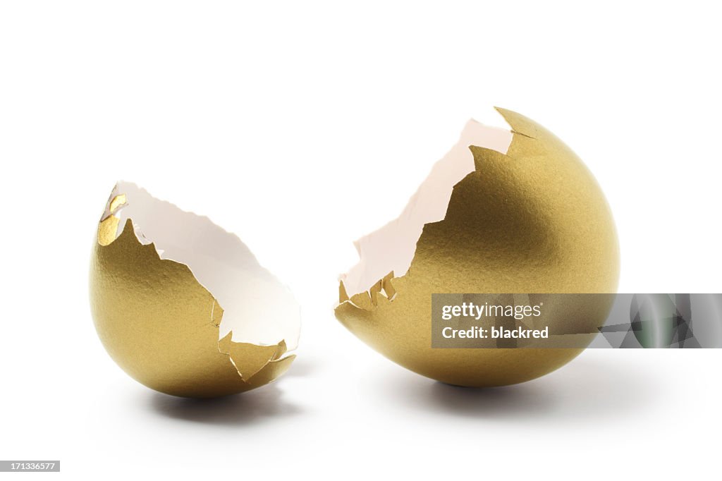 Cracked Open Gold Egg Shell on White Background