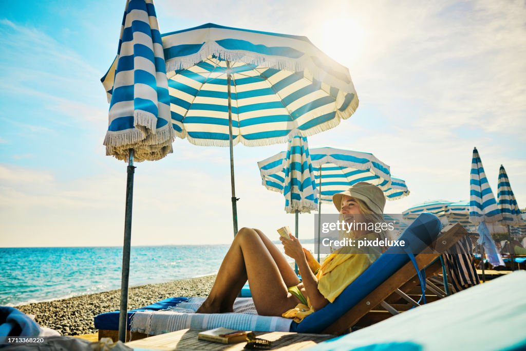 Young adult woman relaxing at a luxury hotel on holiday in the Côte d'Azur, France.