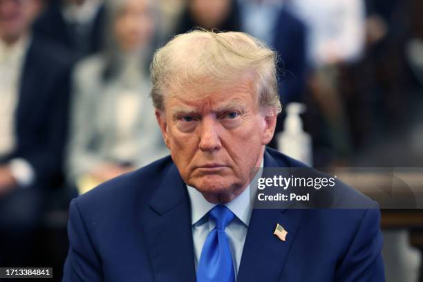 Former U.S. President Donald Trump appears in the courtroom with his lawyers for the start of his civil fraud trial at New York State Supreme Court...