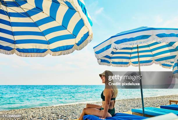 young adult woman relaxing at a luxury hotel on holiday in the côte d'azur, france. - sunshade stock pictures, royalty-free photos & images