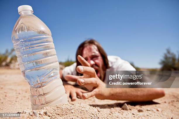 man in desert reaching for water - törstig bildbanksfoton och bilder