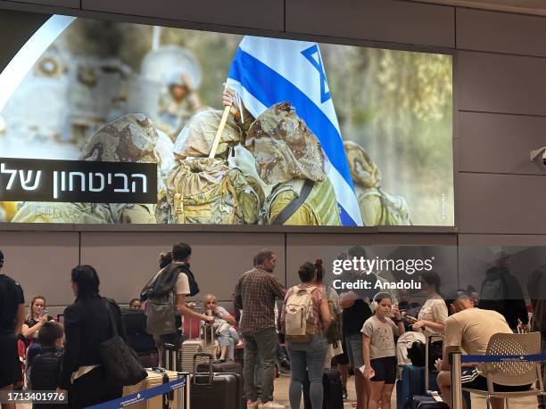 People wait in departing section at Ben Gurion Airport, Israel's only international airport, after many flights from abroad are cancelled due to the...