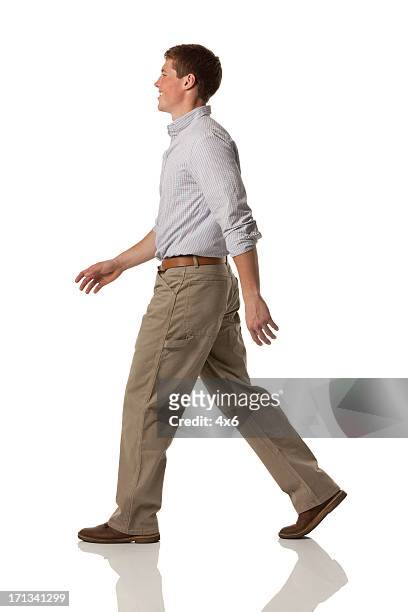 profile of a happy man walking - riem van spijkerstof stockfoto's en -beelden