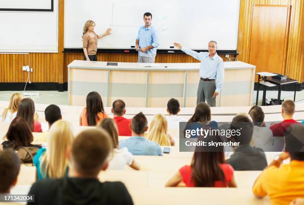 professors and assistants giving a lecture. - assistant professor stock pictures, royalty-free photos & images