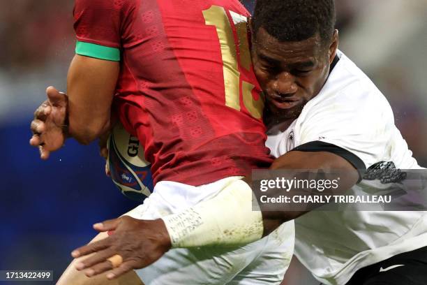 Portugal's full-back Manuel Cardoso Pinto is tackled by Fiji's inside centre Josua Tuisova during the France 2023 Rugby World Cup Pool C match...