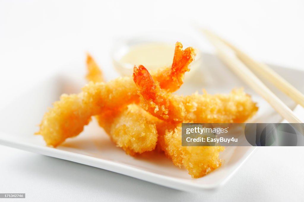 Breaded tempura shrimps with tails on white dish