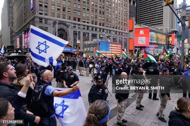 Supporters of Israel face people rallying in support of Palestinians in Times Square in New York on October 8, 2023 after the Palestinian militant...