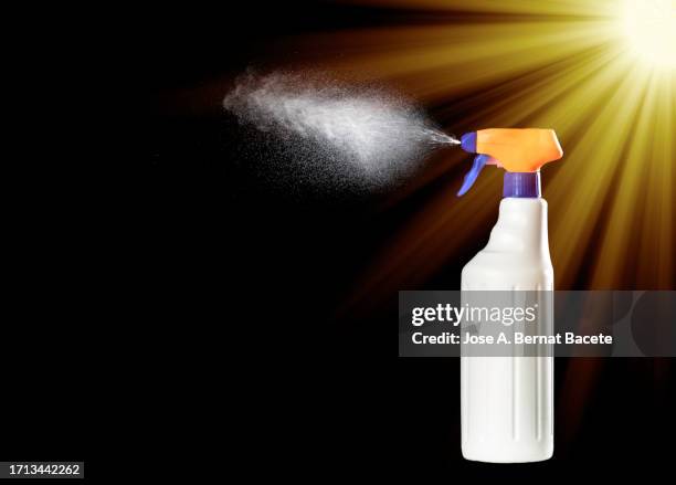 close-up of spray bottle with cleaning or disinfectant fluid on a black background - sprühflasche freisteller stock-fotos und bilder