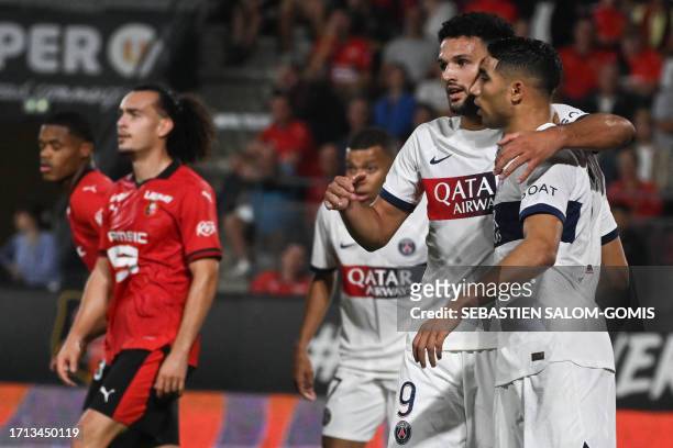 Paris Saint-Germain's Moroccan defender Achraf Hakimi is congratulated by Paris Saint-Germain's Portuguese forward Goncalo Ramos after scoring a goal...