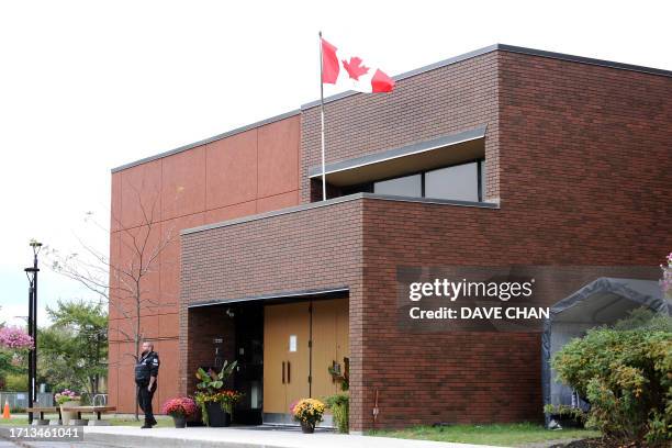 Security guard stands outside the front door of Machzikei Hadas Orthodox synagogue on October 8, 2023 in Ottawa after the Palestinian militant group...
