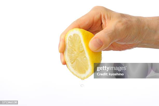 isolated shot of hand squeezing a lemon against white background - lemon juice bildbanksfoton och bilder