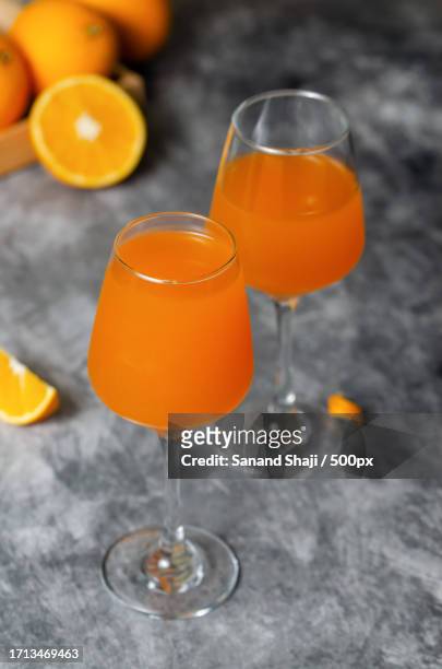 close-up of orange juice on table - sanand ストックフォトと画像