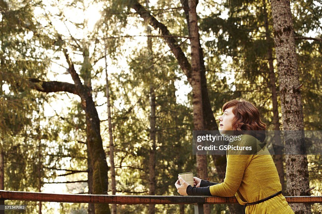 Woman relaxing on deck in nature