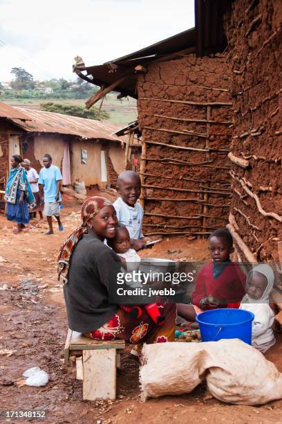 an african woman prepares food with her children - nairobi people stock pictures, royalty-free photos & images