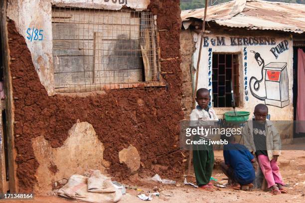 boys selling petrol in an african slum - slum africa stock pictures, royalty-free photos & images