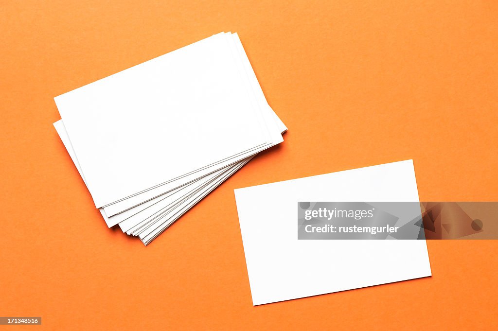 Pile of white notecards on an orange background