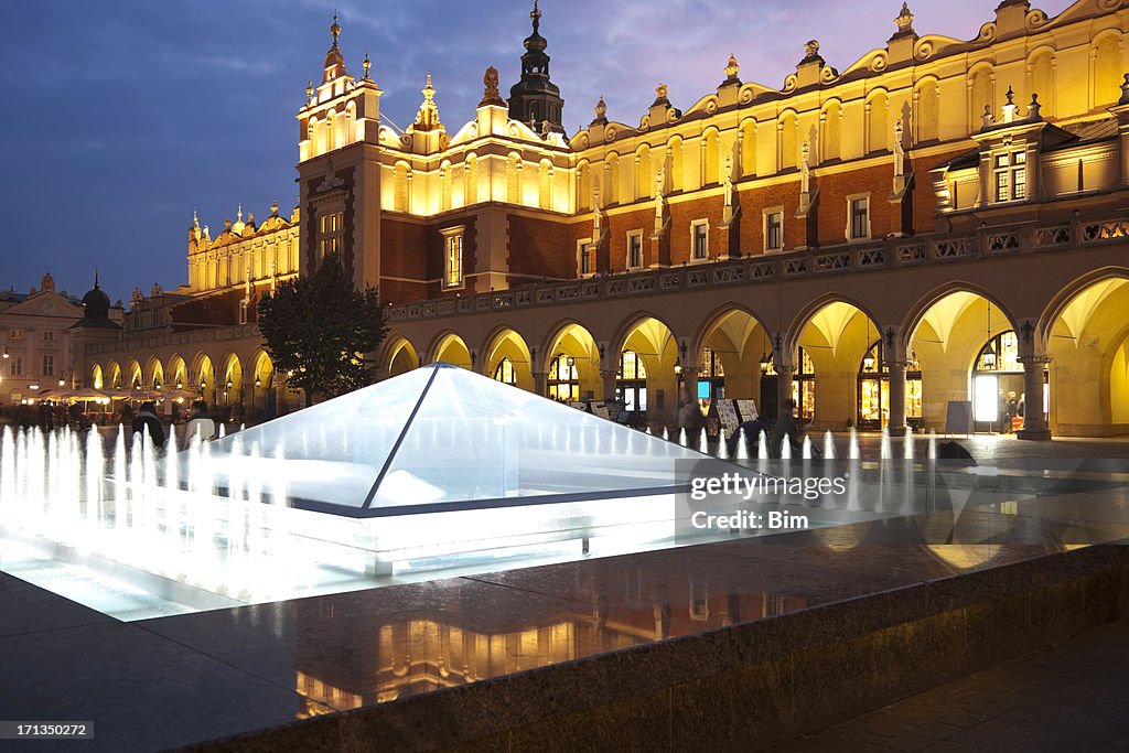 Cloth Hall Sukiennice, illuminated fountain, Market Square, dusk, Cracow, Poland