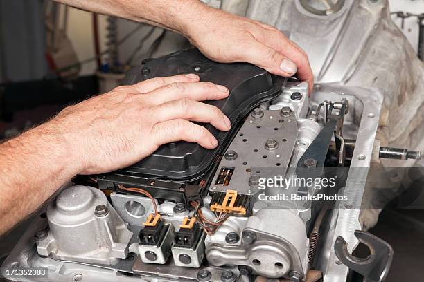 mechanic installing transmission oil filter - automatic stock pictures, royalty-free photos & images