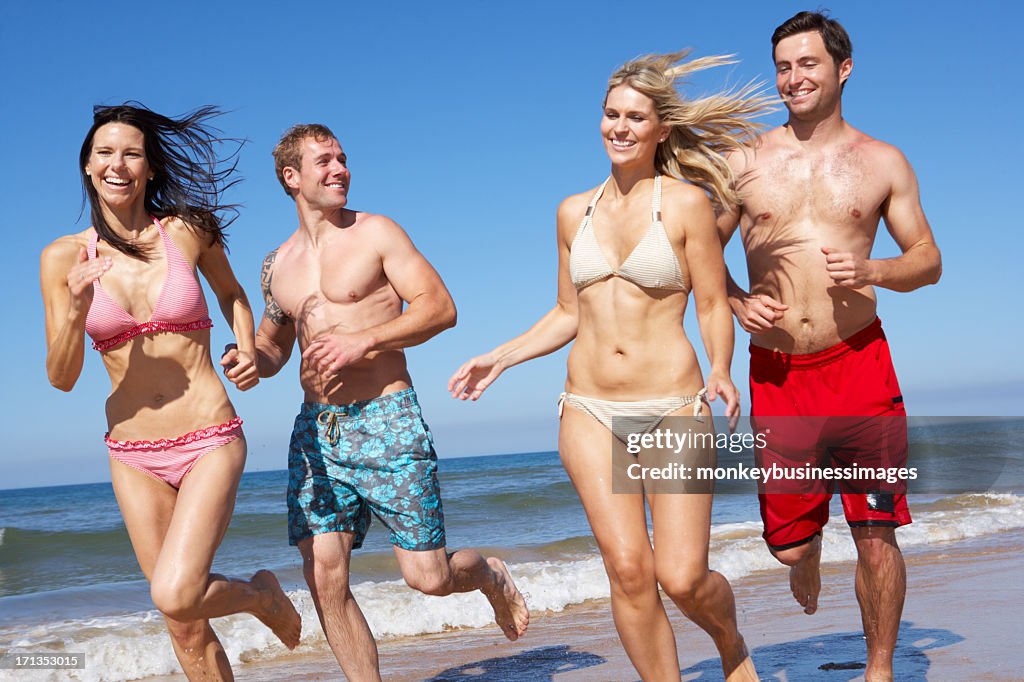 Group Of Friends Having Fun On Beach Holiday Together