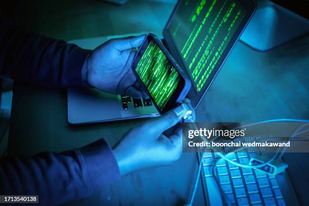 a cropped shot of hands connecting a cable and getting charged to a smartphone. - spyware fotografías e imágenes de stock
