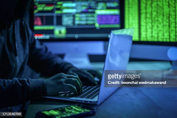 hacker man working on computers in dark the room. - dark web stock pictures, royalty-free photos & images