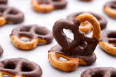 Chocolate dipped pretzels on a baking sheet