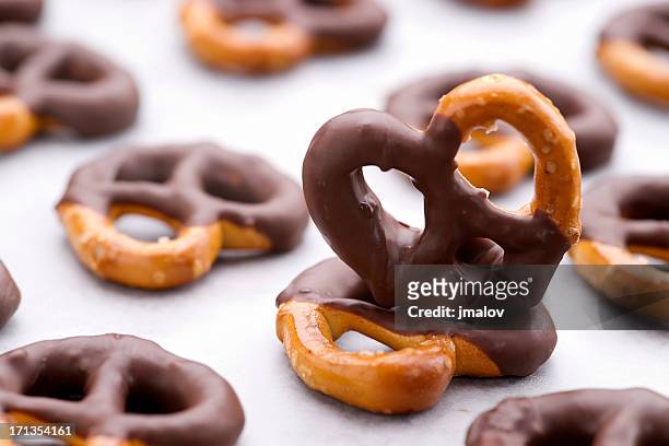 chocolate dipped pretzels on a baking sheet - pretzel stock pictures, royalty-free photos & images