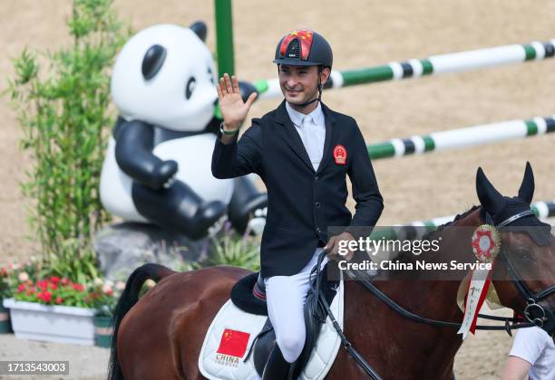 Hua Tian of Team China competes in the Equestrian - Eventing Jumping Team Final & Ind Final on day nine of the 19th Asian Games at Tonglu Equestrian...