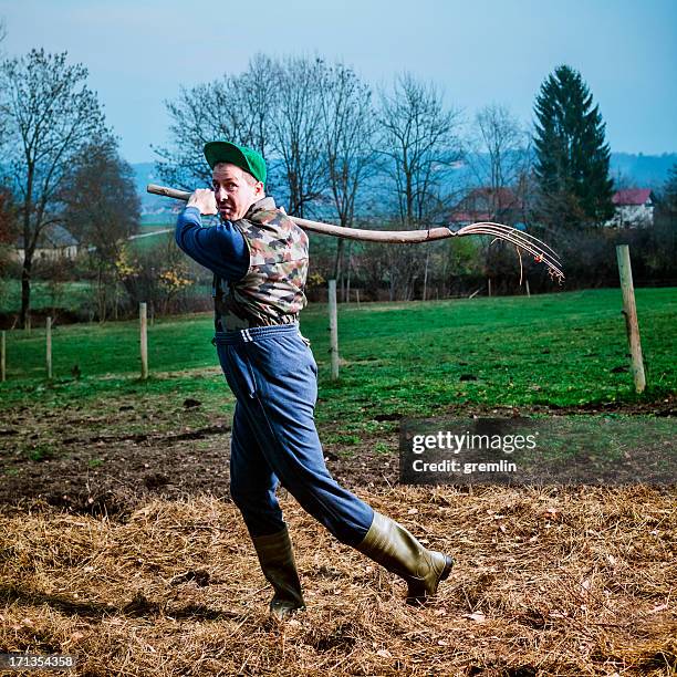 angry farmer threatening with pitchfork - pitchfork agricultural equipment stock pictures, royalty-free photos & images