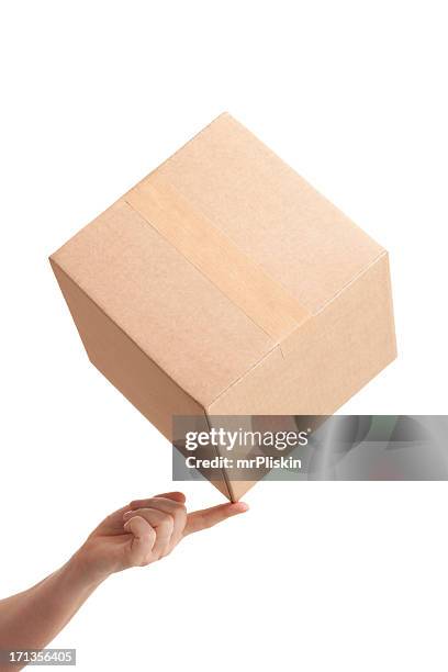 tip of cardboard box balancing on fingertip - smooth stock pictures, royalty-free photos & images