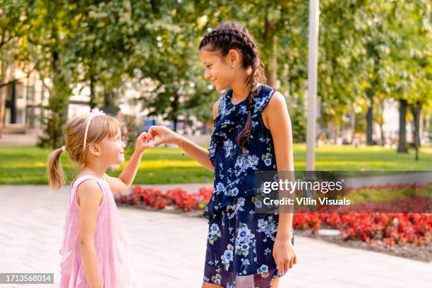 two little girls make shape of heart with hands - showing kindness stock pictures, royalty-free photos & images