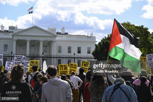 People, holding placards and Palestinian flags, gather to support Palestine in front of the White House in Washington DC, United States on October...