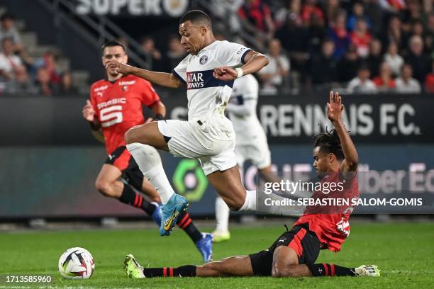 Rennes' French defender Lorenz Assignon tries to tackle Paris Saint-Germain's French forward Kylian Mbappe during the French L1 football match...