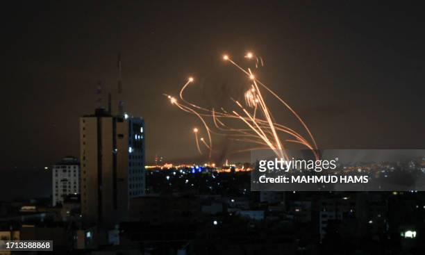 An Israeli missile launched from the Iron Dome defence missile system attempts to intercept a rocket, fired from the Gaza Strip, over the city of...