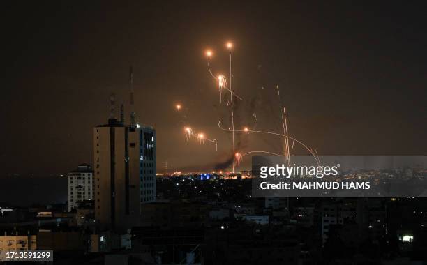 An Israeli missile launched from the Iron Dome defence missile system attempts to intercept a rocket, fired from the Gaza Strip, over the city of...