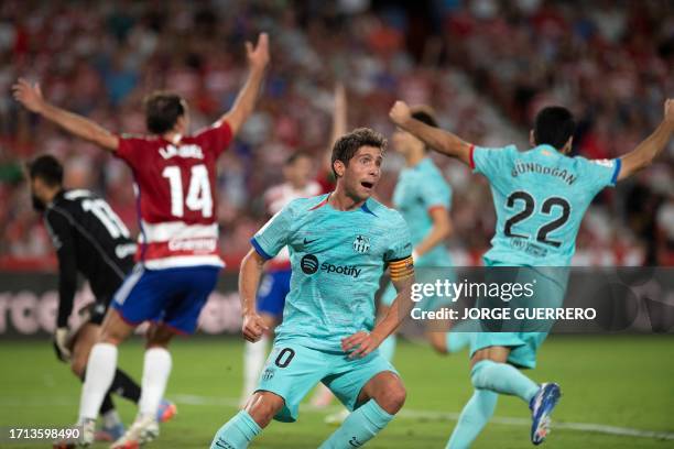 Barcelona's Spanish midfielder Sergi Roberto celebrates after scoring his team's second goal during the Spanish league football match between Granada...