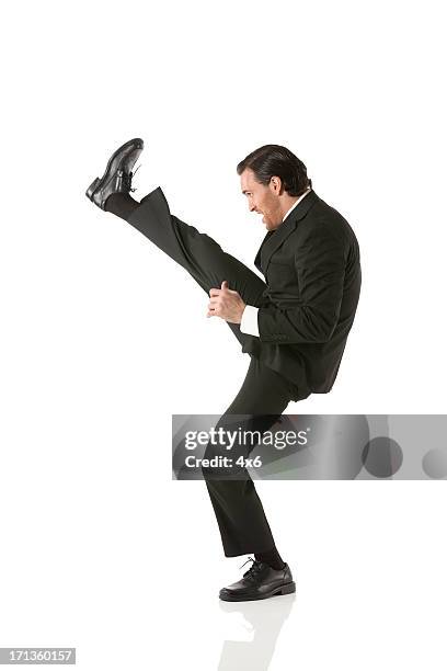 businessman kicking - guy kicking stock pictures, royalty-free photos & images