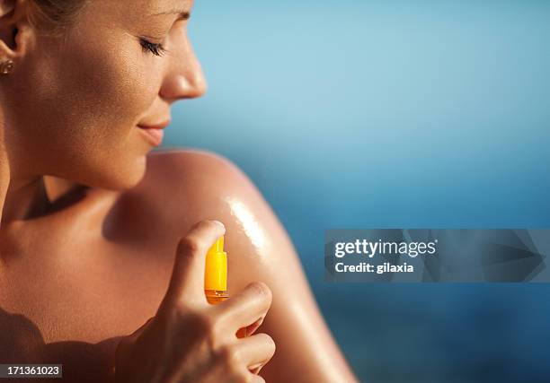 applying suntan lotion. - sun cream stock pictures, royalty-free photos & images