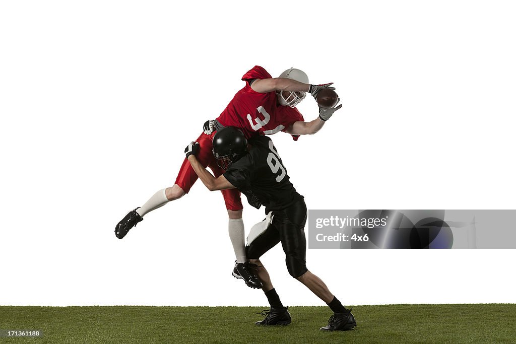 Two american football players in action