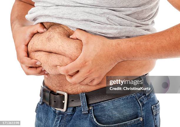 overweight man grabbing his gut - belly fat stock pictures, royalty-free photos & images