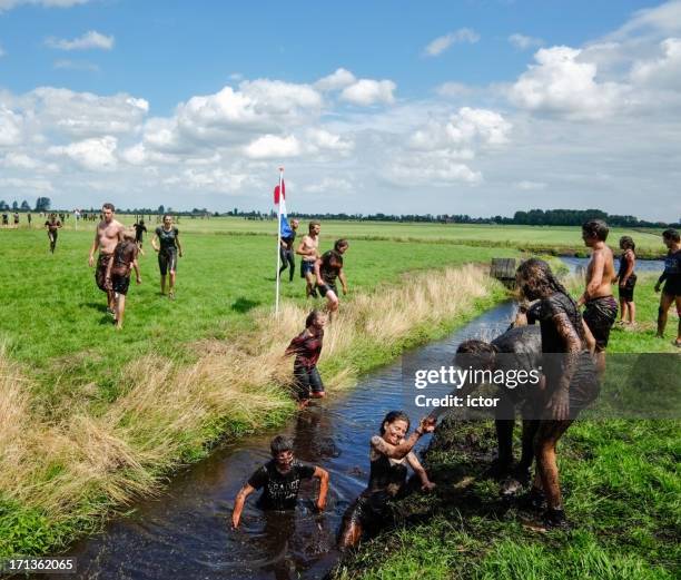 mud run in monnickendam - running netherlands stock pictures, royalty-free photos & images