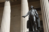 Statue of George Washington Stands by Columns