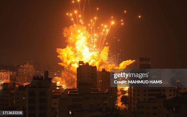 Missile explodes in Gaza City during an Israeli air strike on October 8, 2023. Srael, reeling from the deadliest attack on its territory in half a...