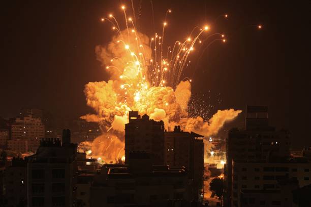 Missile explodes in Gaza City during an Israeli air strike on October 8, 2023. Srael, reeling from the deadliest attack on its territory in half a...