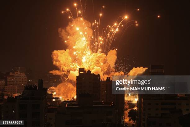 Missile explodes in Gaza City during an Israeli air strike on October 8, 2023. Srael, reeling from the deadliest attack on its territory in half a...