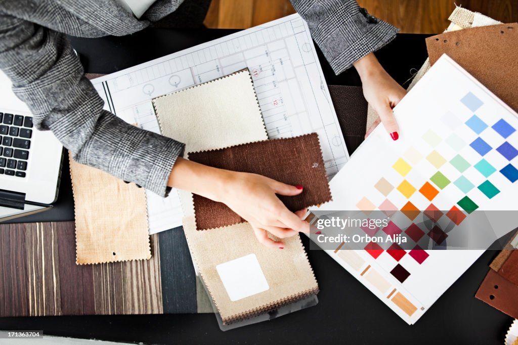 Woman picking out swatches from desk